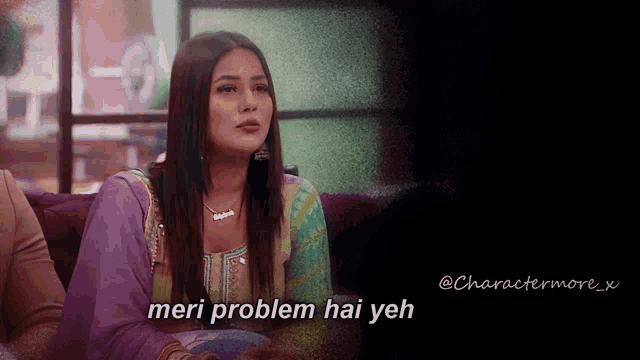a woman sitting on a couch with the words meri problem hai yeh written on the bottom