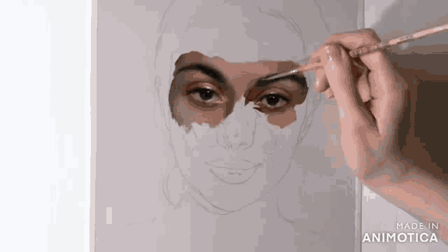 a person is painting a woman 's face with a brush and the words made in animatica on the bottom