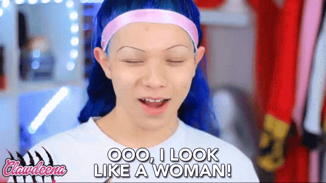 a woman with blue hair is wearing a headband and says " ooo i look like a woman "