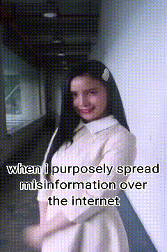 a woman in a white dress is standing in a hallway with the words when i purposely spread misinformation over the internet below her