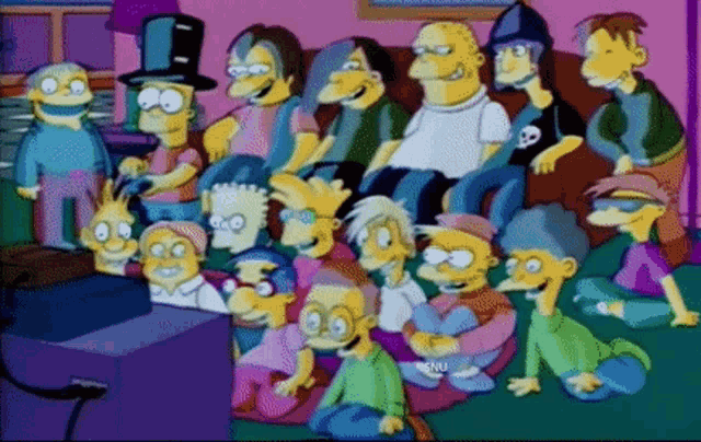 a group of cartoon characters are sitting in front of a television with the letters snu on the bottom right