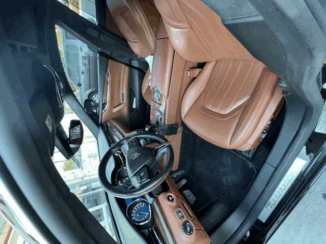 the inside of a maserati car with the steering wheel visible