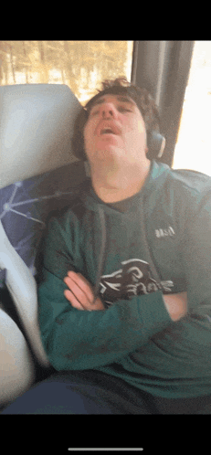 a man wearing a philadelphia eagles sweatshirt is sleeping