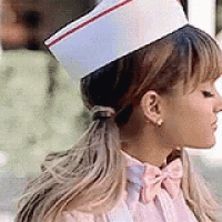 a woman is wearing a nurse 's hat and a pink bow tie .