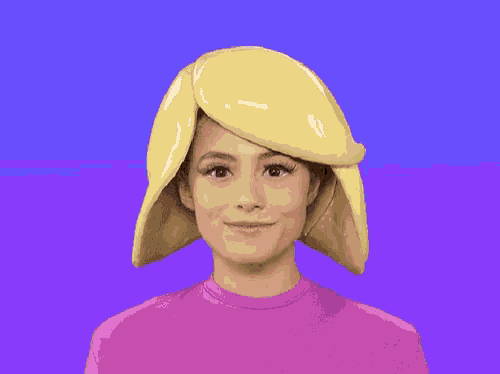 a woman wearing a pink shirt and a yellow hat is making a funny face .