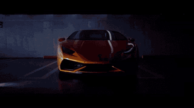 a yellow sports car is parked in a dark parking garage