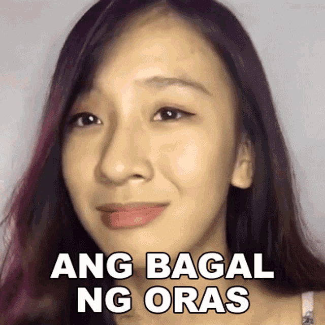 a close up of a woman 's face with a sticker that says ang bagai ng oras .