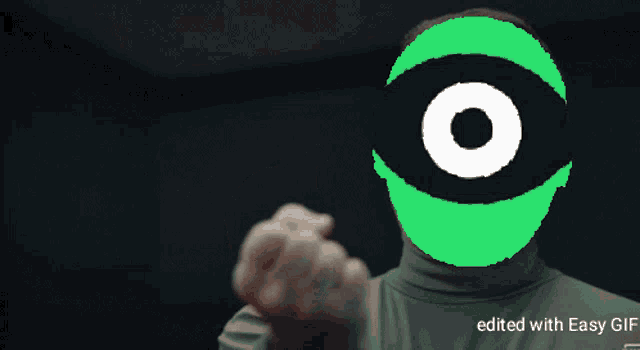 a person giving a thumbs up with a green eye in the background