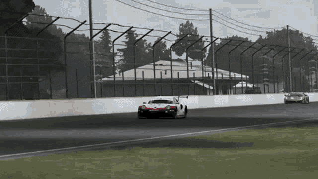 a porsche race car is driving on a race track
