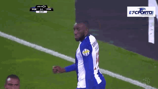 a soccer player in a blue and white uniform with the number 13 on his back