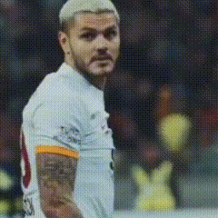 a soccer player with a tattoo on his arm is looking at the camera