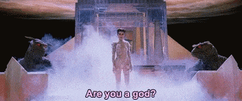 a man is standing in front of a building with the words are you a god