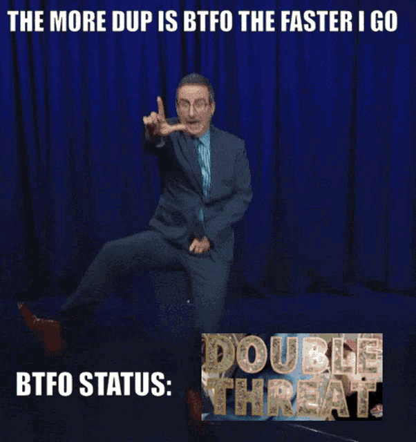 a man in a suit and tie is dancing in front of a blue curtain with the words double threat below him