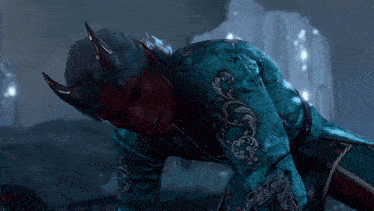 a demon with horns is wearing a blue embroidered jacket