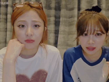 two girls are sitting next to each other and the number 10,038 is visible