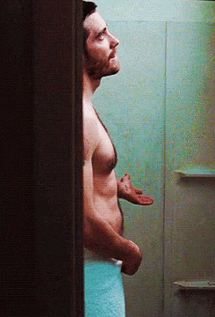a shirtless man with a towel around his waist