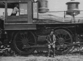 a black and white photo of a man standing in front of a train .