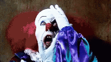 a pixelated image of a scary clown covering his face with his hand