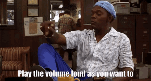 a man in a blue hat says " play the volume loud as you want to " while sitting in a chair