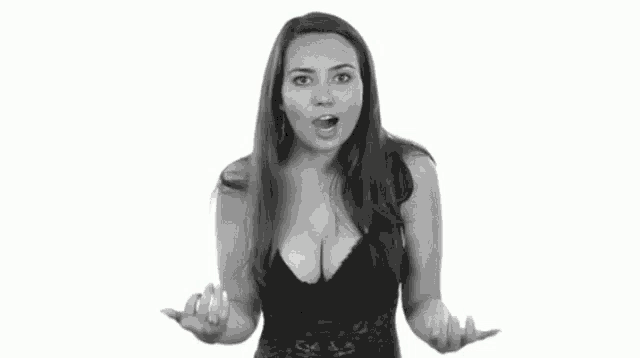 a woman in a black bra is making a funny face in a black and white photo .