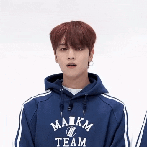 a young man wearing a blue maikm team sweatshirt