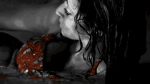 a black and white photo of a woman in a bathtub