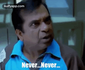 a man in a blue shirt is making a funny face and saying `` never never '' .