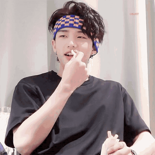 a man wearing a headband is eating french fries and the word objet is on the bottom