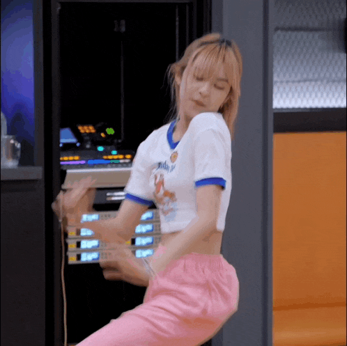 a woman wearing a white shirt that says ' daddy ' on it is dancing