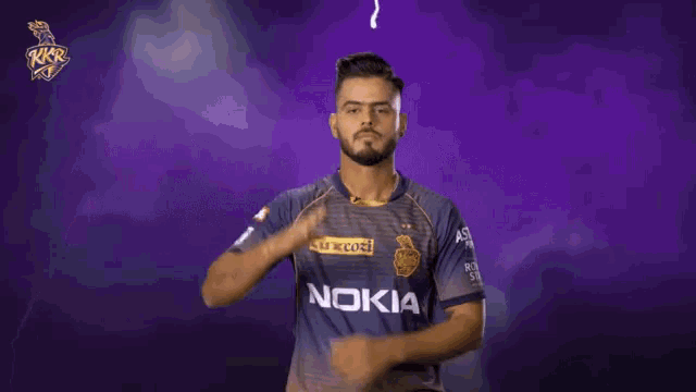 a man wearing a nokia shirt is making a gesture