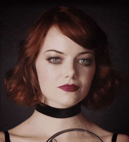 a woman with red hair and a black choker
