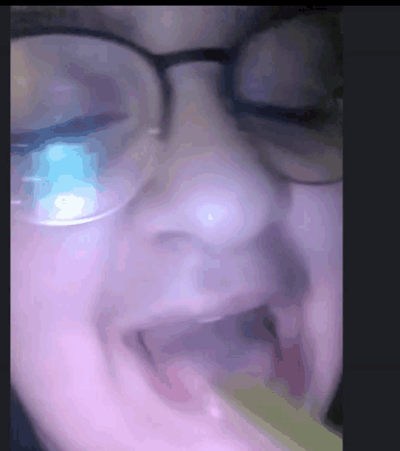 a close up of a person 's face with glasses