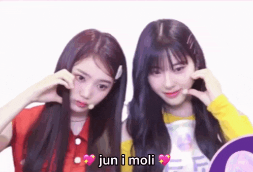 a couple of girls standing next to each other with the words jun i moli on the bottom