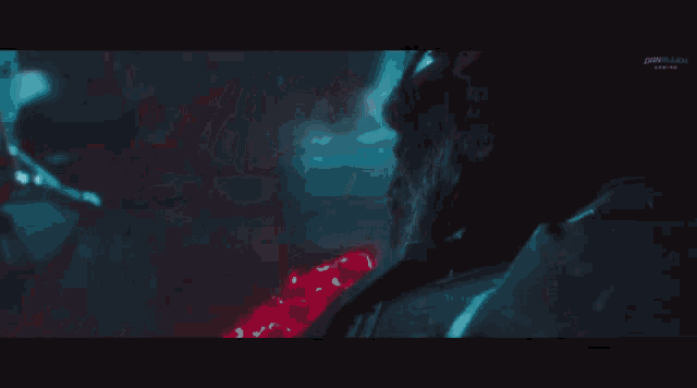 a close up of a person 's face with a blue light behind them