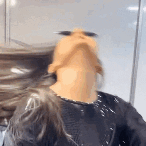 a close up of a person 's face with their hair blowing in the wind .