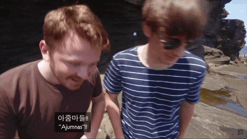 two men are standing next to each other and one of them says " ajunnas "
