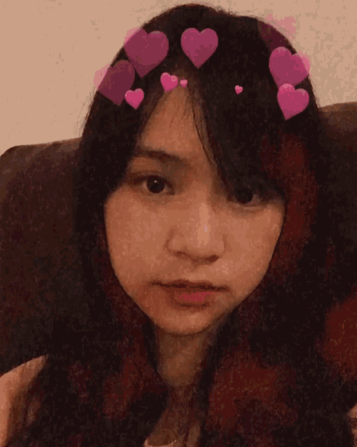 a girl with pink hearts on her head