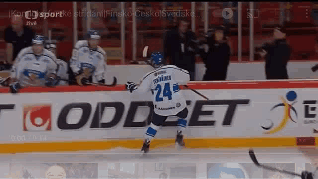 a hockey player with the number 24 on his jersey is skating on the ice