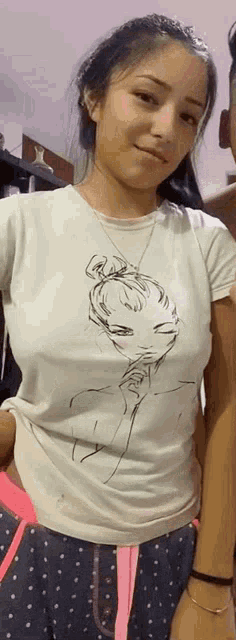 a woman is wearing a white t-shirt with a drawing of a woman on it