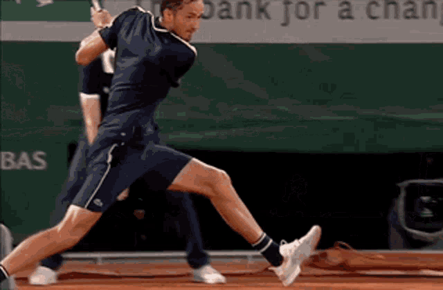 a tennis player is jumping in the air while holding a tennis racquet in front of a bank for a change banner