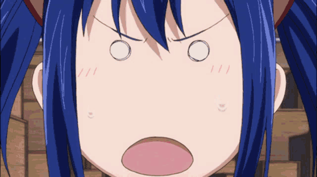 a close up of a girl with blue hair making a funny face