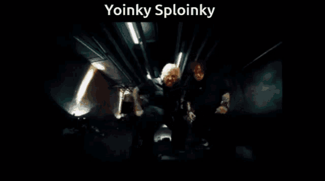two men singing into microphones in a dark room with the words yoinky sploinky below them
