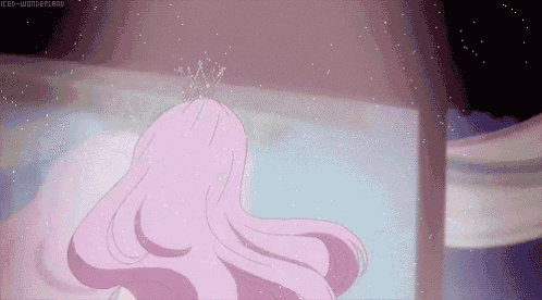 a girl with long pink hair and a tiara on her head .