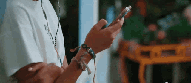 a close up of a person 's hands holding a cell phone .