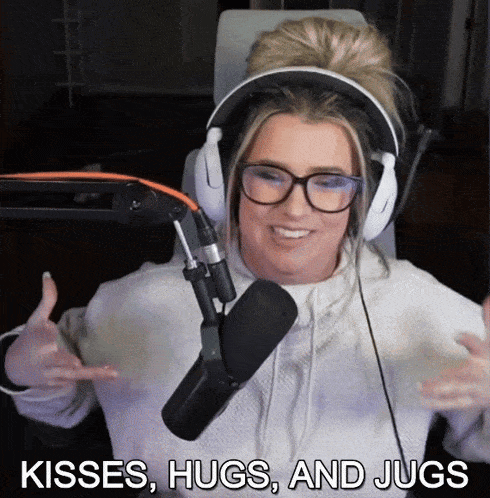 a woman wearing headphones and glasses is sitting in front of a microphone and says kisses hugs and jugs