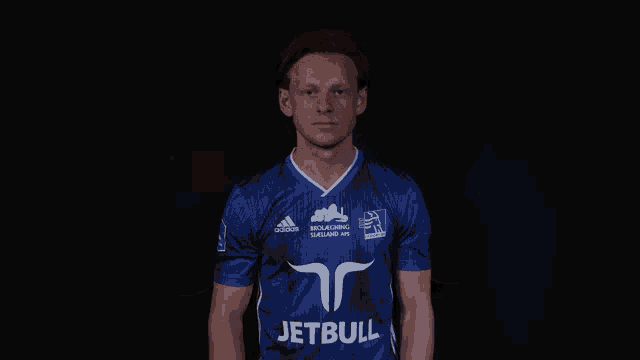 a man wearing a blue jersey that says jetbull on it