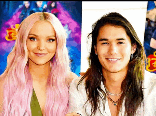 a woman with pink hair and a man with long hair are posing for a picture together