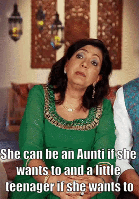 a woman in a green dress says she can be an aunti if she wants to and a little teenager if she wants