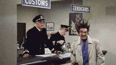 a man with a mohawk stands in front of a sign that says customs
