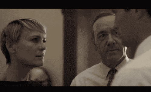 a man and woman are looking at each other in a black and white photo
